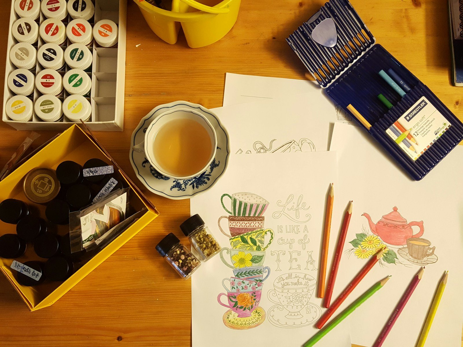 adult coloring for stress relief - black and white ceramic mug on brown wooden table